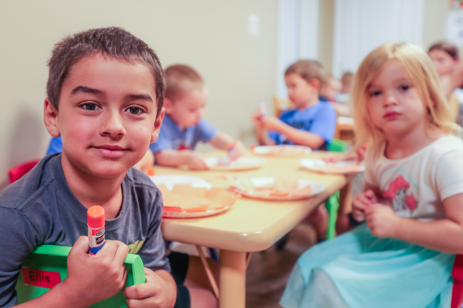 Kids take a break from a craft activity at daycare.