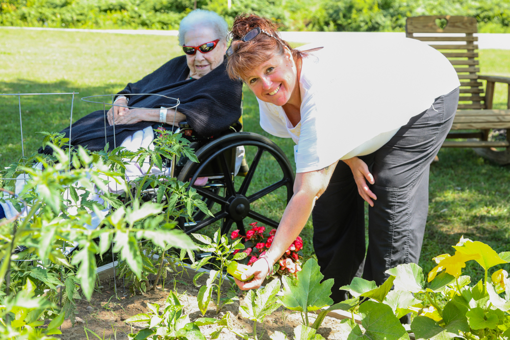 Clifton Fine Hospital volunteer with resident outside