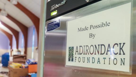 Refrigerator with sign that says "Made possible by Adirondack Foundation"