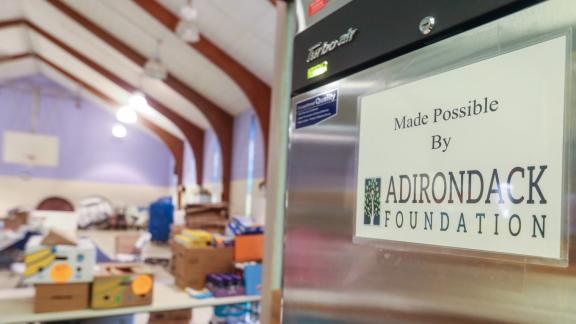 Refrigerator with sign that says "Made possible by Adirondack Foundation"